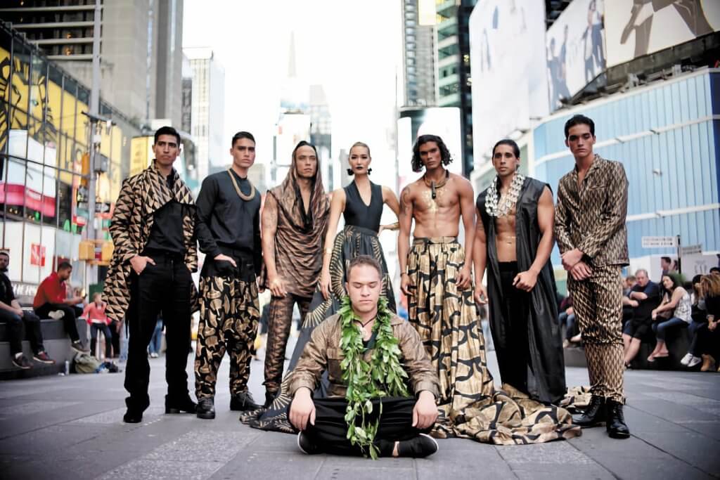 A group of Kanaka Maoli artists wearing gold and black clothing.