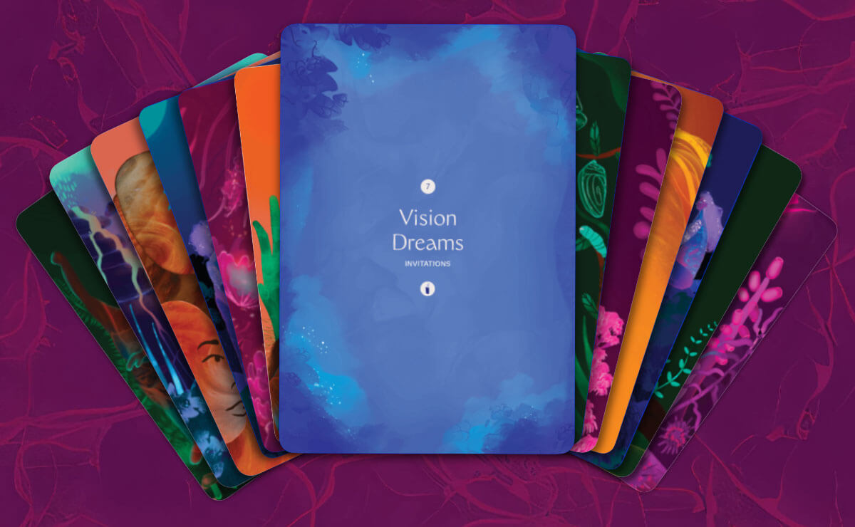 A digital illustration of various green, blue, orange, and red cards from the Mixed Metaphor Learning Deck fanned out in a rough arc. In the center of the arc, on top of all the other cards, is a blue card with the title "Vision Dreams," followed by the word "Invitations," in white centered text in the middle of the card. A small white circle above this text displays the number "7," and a small white circle below this text displays a tiny blue candle icon.