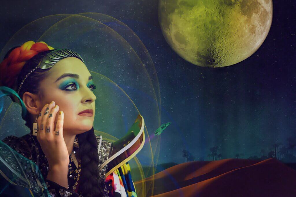 The poster from Positive Vibration National The Opera depicts Sol Ruiz with colorful braided hair and elaborate makeup gazing contemplatively at a green-tinged full moon. Her futuristic outfit features intricate patterns and bright colors, including sequins and metallic elements. The background depicts a cosmic scene with a starry night sky, a large moon, and a landscape resembling a desert with silhouettes of trees. Glowing orbs and rings encircle the woman, adding to the ethereal, sci-fi ambiance of the image.