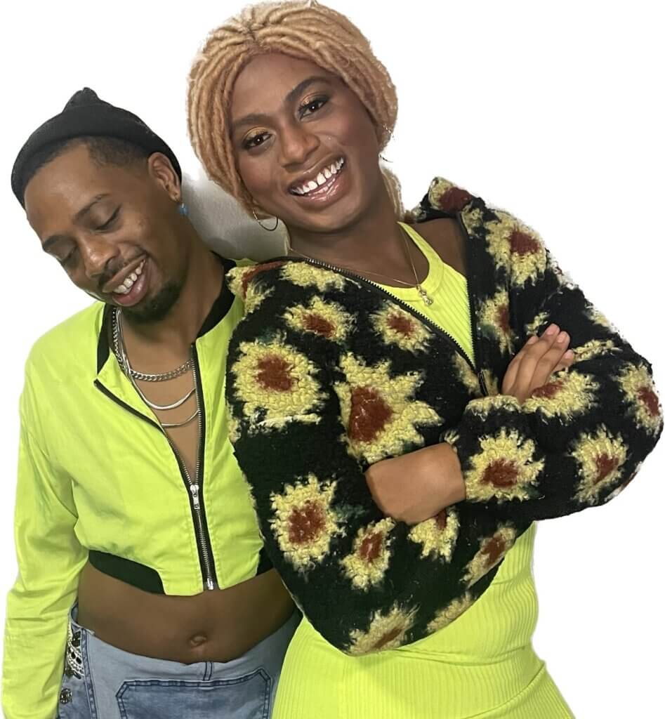 Left to right

White background  

Black queer person eyes closed with a black hat. Silver chains around neck with a lime green crop top jacket. Smiling and looking down. 

Black Trans woman with blonde locs smiling looking into the camera. Wearing a lime green dress and a cropped black and yellow sunflower jacket.  Arms folded.