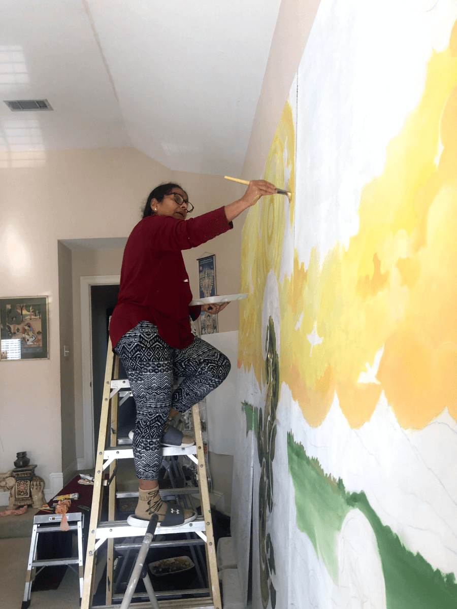 Geeta Dave painting a wall.