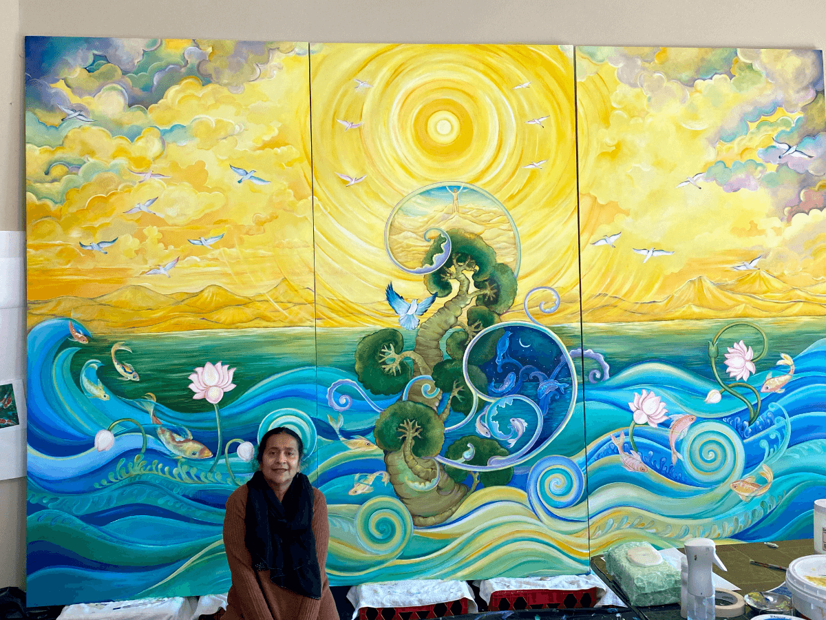 Geeta Dave sits in front of a finished mural.