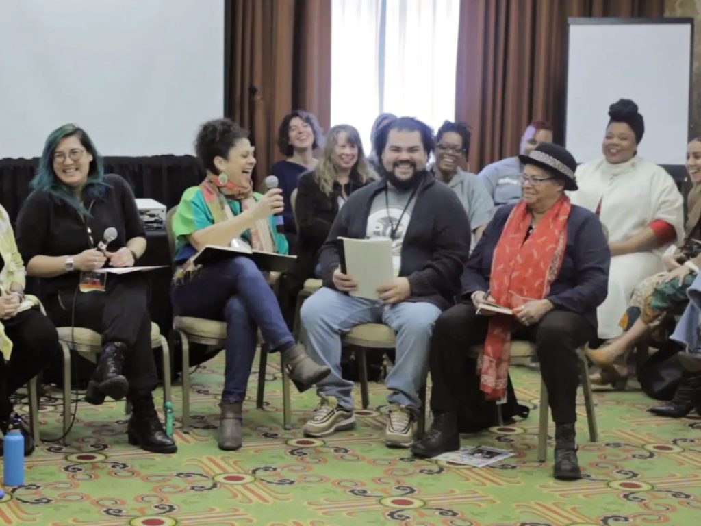 Photo of LANE cohort members The Carpetbag Theatre of Knoxville, Tennessee, and Pangea World Theater of Minneapolis, Minnesota interviewing each other at the 2019 National Performance Network Conference.