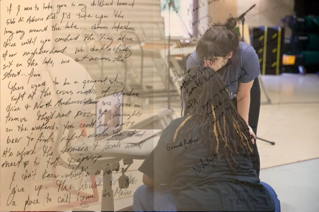 Image of Kate ( a white woman with brown hair) and Kayla (a Black woman with long locs) are squatting and looking at a computer. There is handwritten journal text overlaid on the left-side of the photo.